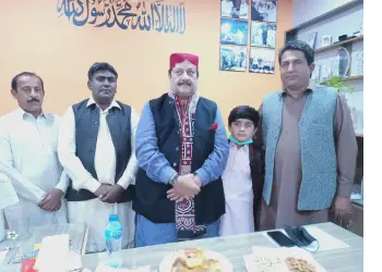Abdul kerio ,Sardar of Keerio as chief guest puts on this shawl given by Muhammad Ameen Keryo CEO Sindhica Reforms Society Nawabshah