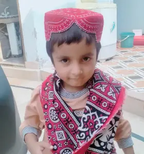 pic kid wit topi and ajrak worn